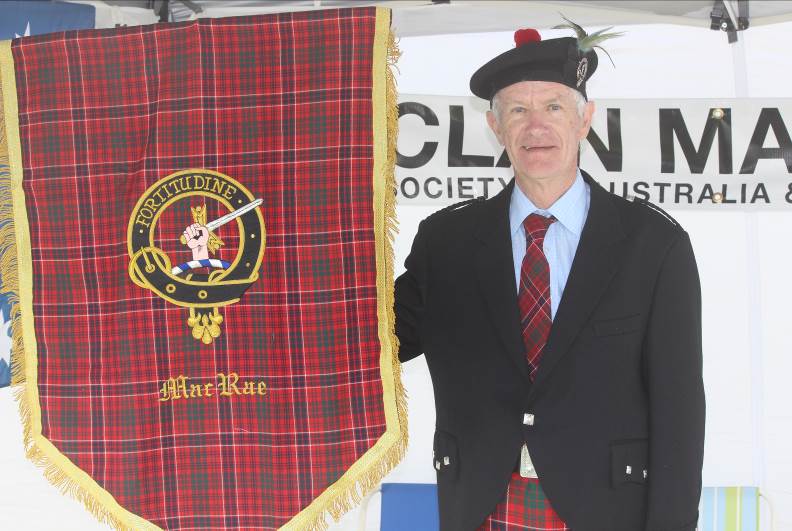 Allan Smith, Vice President of Clan MacRae Society with the MacRae banner